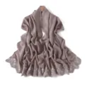 Detailed view of the elegant dusty purple scarf featuring delicate white floral embroidery. - Apricot Gray