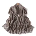 Close-up detail of the elegant floral embroidered edge and glossy silky texture scarf shawl. - Firmiana Green
