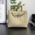 Beige leather woven shoulder crossbody bag with metal wood handle and knot detail. - Oatmeal