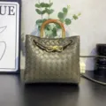 Handcrafted woven leather handbag with wooden handle and metal knot detail for stylish daily commute. - Army Green