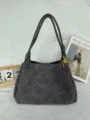 Detailed view of the dark grey faux suede woven shoulder bag with chic metal knot hardware. - Medium 29.5*17.5*18.5cm / Gray
