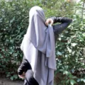 Solid color chiffon hijab detail shot showing graceful draping and elegant fabric texture. - Dark Grey