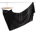 Detailed black asymmetrical wrap skirt featuring sparkling rhinestones and elegant metal tassels. - Black