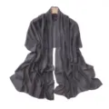 Detail view of dark gray chiffon scarf featuring sparkling rhinestone polka dots and elegant drape. - Smoke Gray
