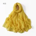 Close-up detail of the lightweight solid yellow polyester voile scarf, soft fabric texture. - 15
