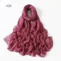 Detail view of a lightweight solid color sheer voile scarf, elegant draped fabric style. - 24