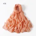 Detailed view of the lightweight solid color peach pink polyester voile long scarf closeup. - 36