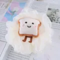 Close-up detail of fluffy white shower bath sponge with cute toast plush cartoon patch. - Cookie