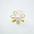 Detailed close-up of a floral pearl ring featuring gold-plated brass and shimmering mother-of-pearl. - Ring / Acrylic Beads / Gold
