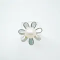 Detailed view of silver tone flower ring accessory featuring white pearl and mother of pearl petals. - Ring / Acrylic Beads / Silver