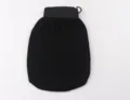 Black exfoliating bath glove with elastic wide cuff and hanging loop, soft and durable texture. - Black