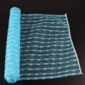 Blue and white jacquard exfoliating bath towel detail, mesh woven texture for body scrubbing. - Blue