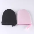 Close-up detail view of soft flocking self-tanning mitts, lotion applicator for smooth skin care. - S / Black