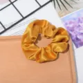 Glossy golden satin hair scrunchie, elegant silk fabric hair tie for women daily styling. - Golden