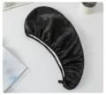 Detail view of the black double-layer satin dry hair cap, showing the soft fabric texture and hanging loop. - Black