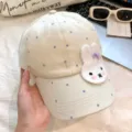 Adorably cute rabbit embroidered baseball cap with purple polka dots for daily casual wear. - One Size / Off White