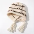 Cozy ribbed knit earflap beanie with contrast brown stripes and playful tassels for winter. - One Size / Off White