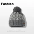 Detailed close-up of winter warm pom-pom knit hat, thick wool jacquard cozy style. - Light Gray