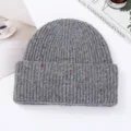 Detailed shot of the thick knitted beanie with colorful speckles, winter warm grey wool hat. - Light Gray