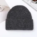 Close-up detail of the dark gray speckled knit beanie, showing soft thick texture and colorful flecks. - Dark Gray