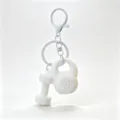 Mini gym equipment keychain detail, white dumbbell and kettlebell charms accessory. - White