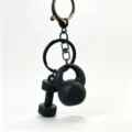 Mini fitness equipment keychain with dumbbell and kettlebell charms, stylish black metal finish. - Black