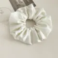 White satin hair scrunchie detail shot, elegant shiny hair accessory for women. - Milk White