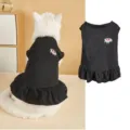 Detail shot of cute black pet dress featuring a sweet watermelon patch and ruffled hem style. - XS / Black