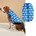Dog vest detail showing warm quilted fabric, blue bow pattern, and convenient back zipper design. - XS / Blue