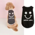 Detailed close-up of black puppy vest featuring white smiley face and stylish letter print. - S / Black