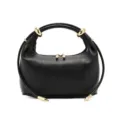Black leather dumpling handbag with chic gold hardware, minimalist style, detail view. - Black