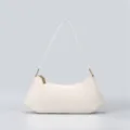 Minimalist off-white underarm shoulder bag detail showing premium handbag hardware. - White