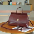 Vintage burgundy top-handle handbag, retro leather briefcase and chic crossbody satchel. - Red