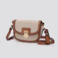Detail shot of retro color-blocked saddle bag with metal clasp and adjustable crossbody strap. - Canvas Brown