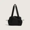 Close-up view of the black nylon gym shoulder bag featuring durable straps and zippers. - Black