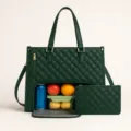 Dark green quilted tote bag lunch compartment detail view with matching small pouch. - Green