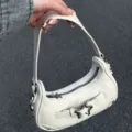 White PU leather shoulder bag with star buckle, chic baguette handbag for women. - White