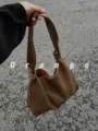 Detailed view of the brown PU leather shoulder bag, highlighting the soft slouchy knotted strap. - Mud Color