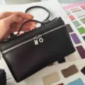 Black litchi pattern PU L19 handbag and cosmetic bag with top handle and silver hardware detail. - Black