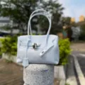 Light blue PVC jelly shoulder bag, stylish transparent tote handbag with lock design. - Icy Blue Small