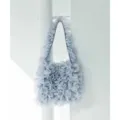 Close-up detail view of light blue mesh ruffled shoulder tote bag texture and design. - Blue
