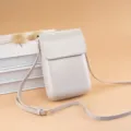 Minimalist vertical beige crossbody phone bag, compact design with adjustable strap. - Off-White