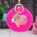 Detailed view of the cute rhinestone sheep plush keychain with fluffy pom pom and gold ring. - Pink Rhinestone Sheep + Rose Red Plush Ball