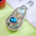 Exquisite full rhinestone swan car key case detailed view, sparkling crystals and metal hardware. - Blue