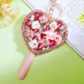 Detailed shot of the sparkling rhinestone heart mirror keychain with floral decor. - A943 Heart Lollipop Mirror Floral Full