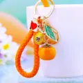 Orange woven leather keychain with persimmon charm, cute bag pendant and gold ring. - Orange Rope + Persimmon Leaf Orange