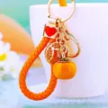 Cute persimmon charm metal keychain detail, exquisite bag pendant and car key ring accessory. - Orange Rope + Wealth Persimmon Orange
