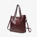 Burgundy oil wax leather tote bag handbag detail view, elegant women shoulder bag design. - Coffee