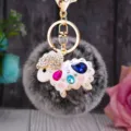 Close-up detail of the cute rhinestone sheep fluffy keychain, showcasing sparkling crystal gems. - White Rhinestone Sheep + Frosted Grass Plush Ball