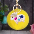 Detailed close-up of the cute sparkling rhinestone sheep plush keychain pendant hardware. - White Rhinestone Sheep + Yellow Plush Ball